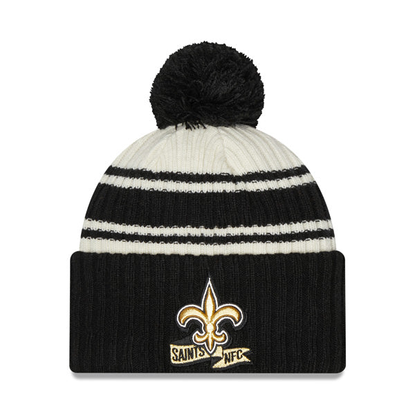 New Orleans Saints New Era 2022 Sideline Sport Cuffed Pom Knit Hat - Cream/Black