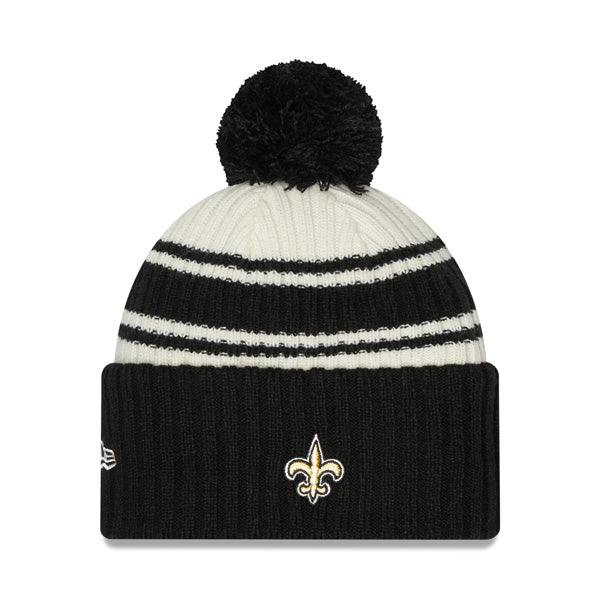 New Orleans Saints New Era 2022 Sideline Sport Cuffed Pom Knit Hat - Cream/Black
